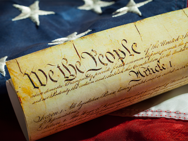 A copy of the Declaration of Independence sits atop an American flag.